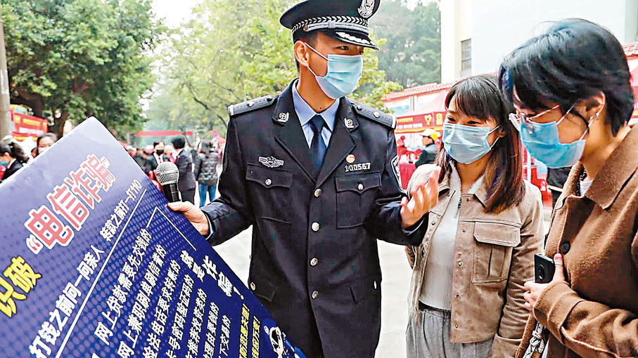 ◆ 早前民警在廣西柳州「雷鋒街市」給市民講解反電信詐騙知識。 資料圖片