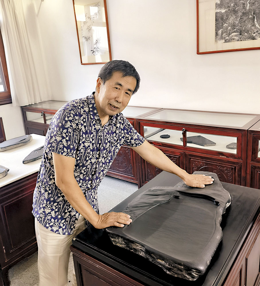 ◆胡中泰與《汨羅江畔》硯台合照。