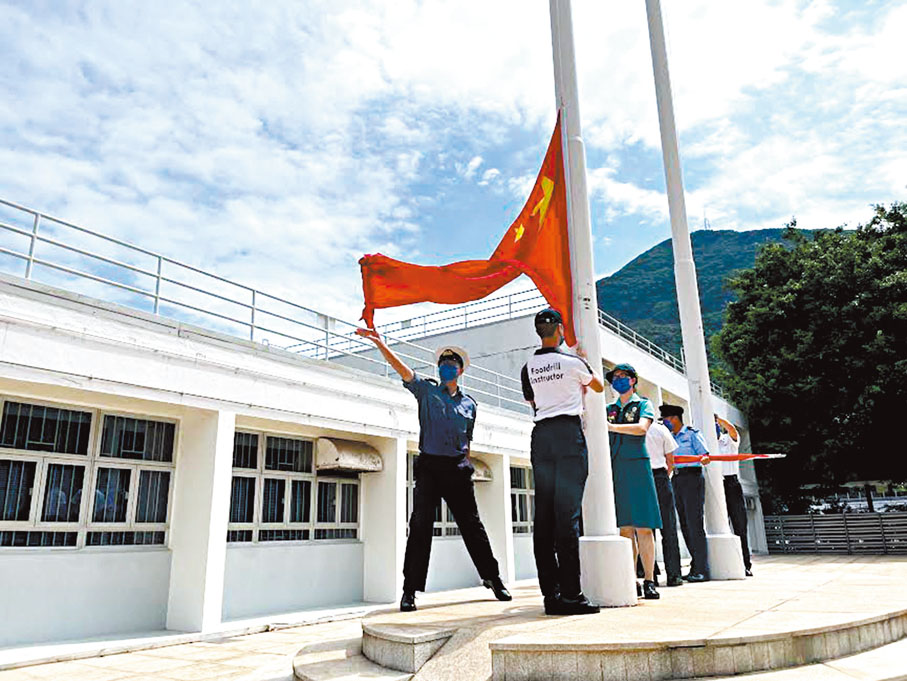 ◆學員在教官指導下完成揚起國旗動作。香港文匯報記者廖傑堯  攝