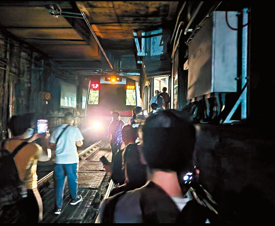 油麻地站列車車門飛脫事故發生後，大批乘客打開車尾門走下路軌徒步逆向步往旺角站。 香港電台圖片