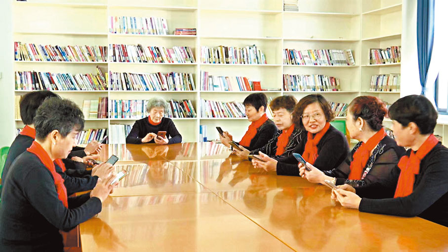 ◆午休期間，胡暉奶奶（中）向老年舞蹈隊的隊員們分享手機裏的雙十一「購物車」。香港文匯報記者俞晝  攝