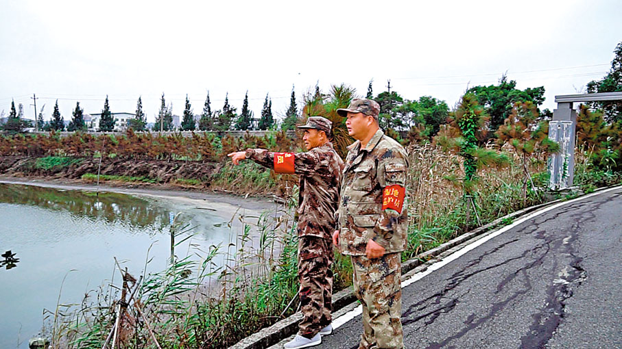 ◆從濕地養殖戶變身濕地管護員的林發金（左）和林寶淦（右）在濕地周圍巡邏。香港文匯報記者蘇榕蓉 攝