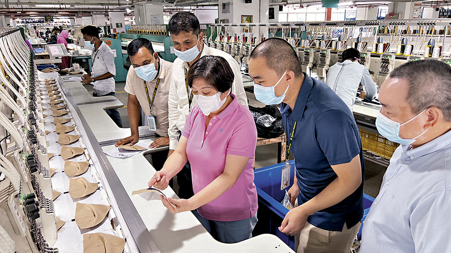 ◆ 顏寶鈴（右三）感恩社會、同事和家庭對自己的支持，讓她能無後顧之憂地「做我所愛、愛我所做」。圖為顏寶鈴在孟加拉工廠視察生產線。 點新聞記者蘇婷  攝