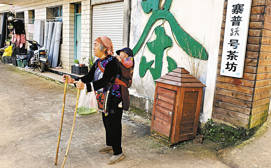 ◆南糯山姑娘寨多揹着孩子的老人。 作者供圖