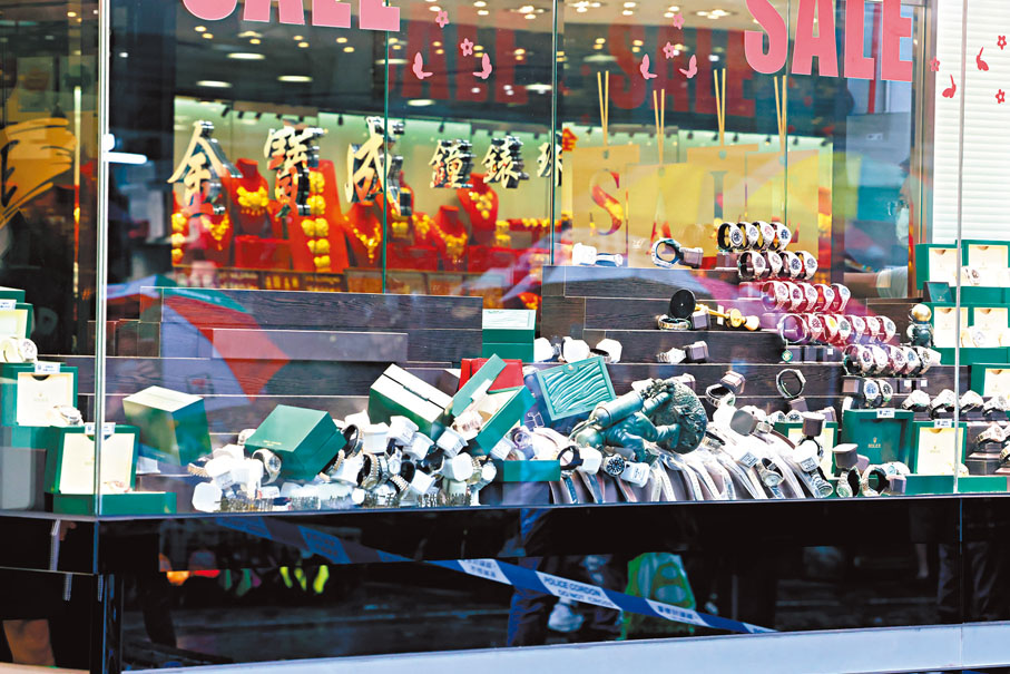 ◆昨日遇劫的屯門啟發徑珠寶行櫥窗一片凌亂。 香港文匯報記者劉友光  攝