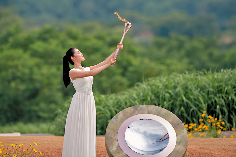 ◆ 採火使者展示聖火。   新華社