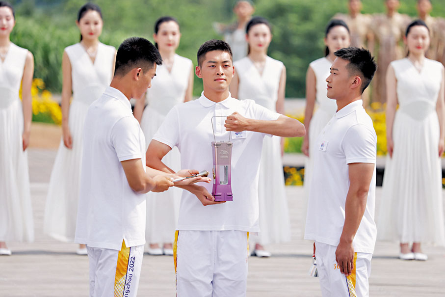 ◆ 火種護衛將火種引入火種燈。中新社/杭州亞運會圖片