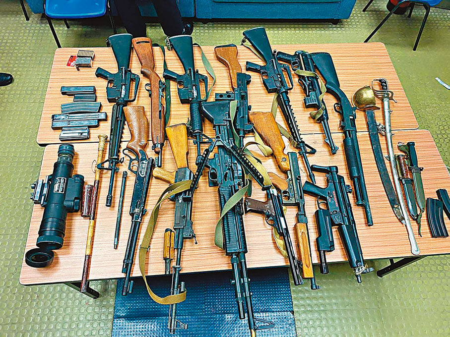 ◆警方展示檢獲的13支長槍、約100發子彈、1把劍和兩把匕首。