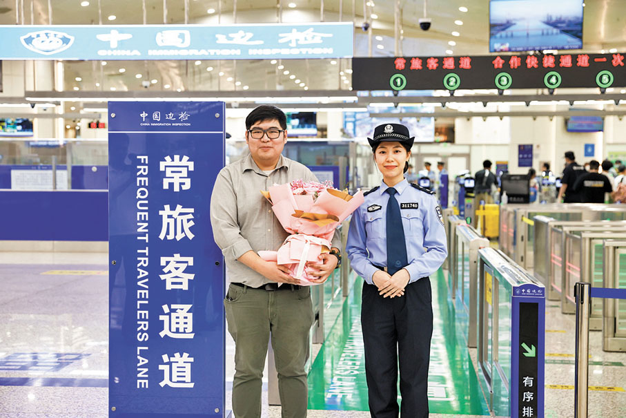 ◆廣東珠海邊檢總站民警為首位經「常旅客通道」出境旅客獻花留念。香港文匯報廣東珠海傳真