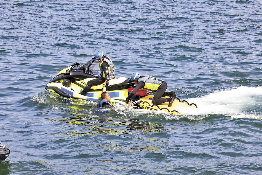 ◆水上電單車隊員示範拯救一名划獨木舟墮海人士。 香港文匯報記者劉友光 攝
