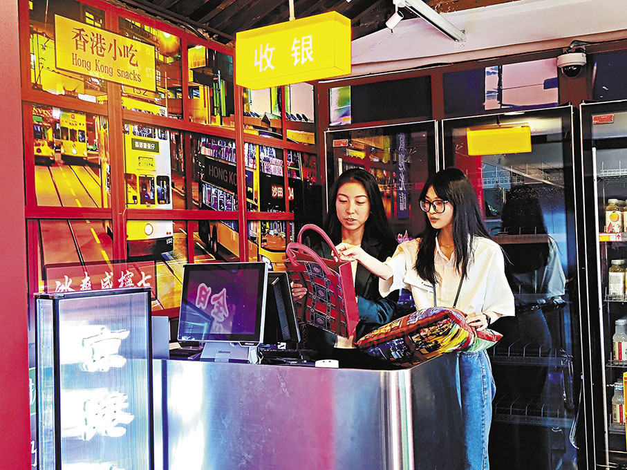 ◆澳生劉玳菱（右）與其指導老師鐵錚在「故宮文創香港空間」整理文創產品。 香港文匯報記者江鑫嫻  攝