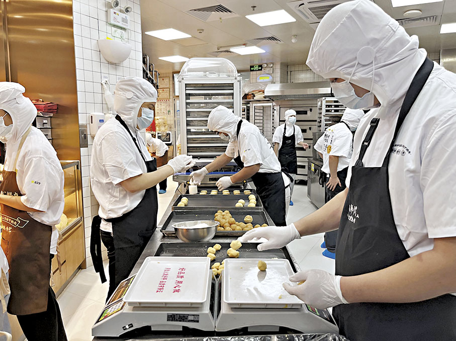 ◆今年中秋節前夕,鮑師傅門店內的糕點師傅忙於製作月餅。 香港文匯報 記者 李望賢 攝