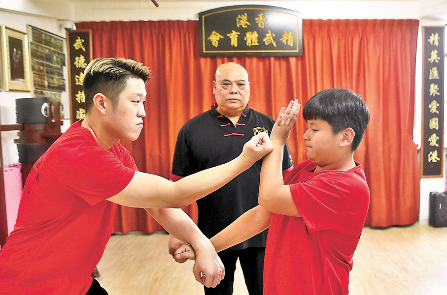 ◆黃耀球（中）指導徒弟練習拳法。