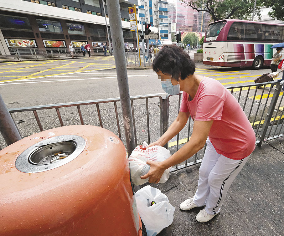 ◆三無大廈住戶盧女士長年將家居垃圾棄置街邊垃圾桶，她擔心，垃圾徵費法例生效後，政府將嚴懲此類行為。 香港文匯報記者涂穴  攝