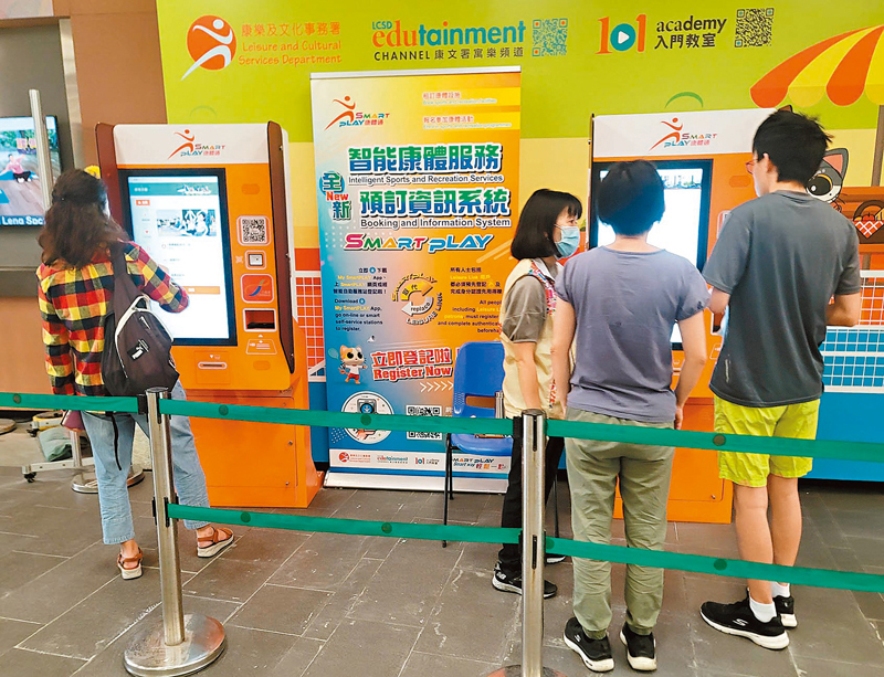 ◆康文署已要求SmartPLAY承辦商修改訂場系統「團隊成員」功能設定。圖為市民正在了解SmartPLAY的使用方法。 香港文匯報記者北山彥  攝