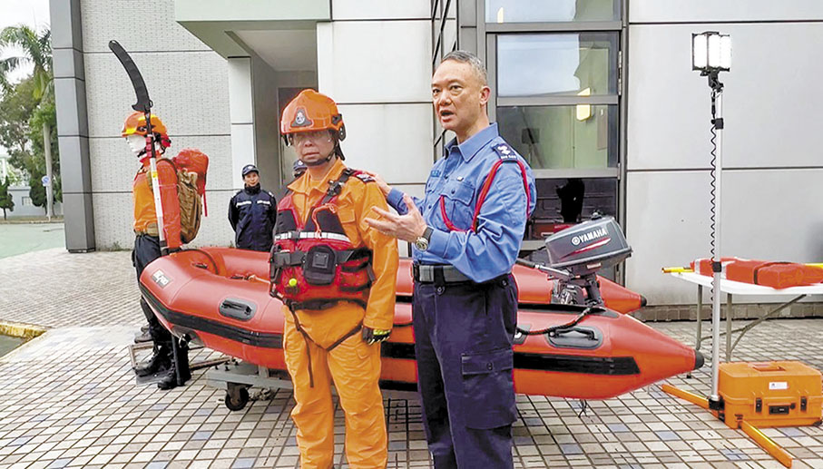 ◆ 趙汝泰（右）介紹水災搶救隊員的裝備。 短片截圖