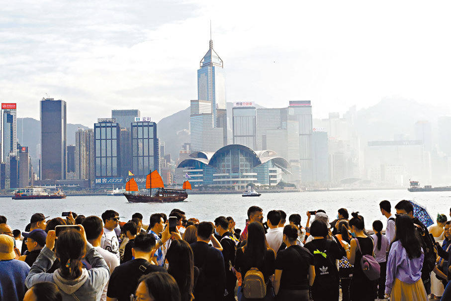 ◆帆船經過維港，人們紛紛舉機拍照。 香港文匯報記者北山彥 攝