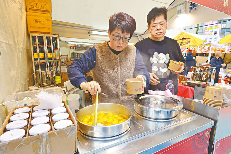 ◆許先生（右）的攤檔售賣脆肉鯇魚魚蛋和蟹黃竹笙翅等美食。 香港文匯報記者北山彥  攝