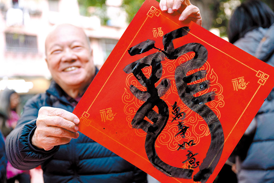 ◆【澳門】老人手舉「龍」字揮春迎新年。 新華社