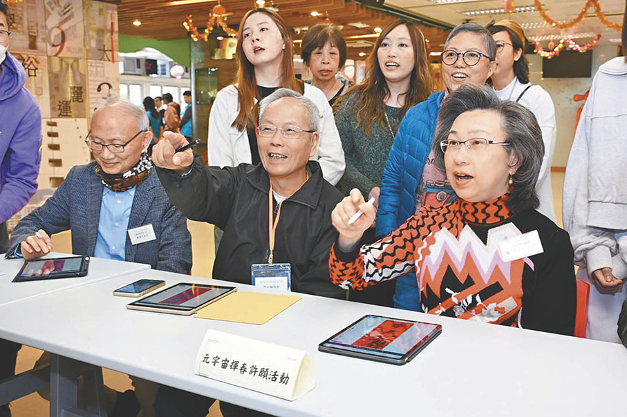 ◆楊何蓓茵（右）與長者一起用平板電腦書寫電子揮春。 Fb圖片