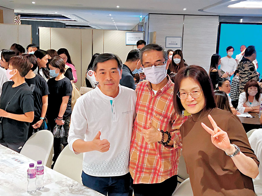 ◆SEASONS PLACE買家瞿先生（中）稱，本身為首輪向隅客，今次斥資約1,100萬元購入1伙三房戶作自住用，覺得價錢都算吸引，「撤辣」後慳不少稅，估計樓市會平穩。左為會德豐地產黃光耀。