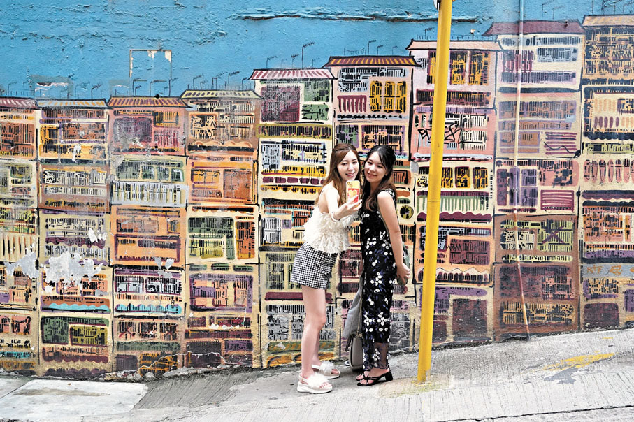 ◆遊客在中上環半山區的壁畫前自拍。香港文匯報記者曾興偉 攝