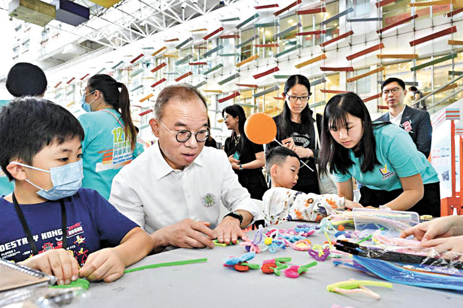 ◆曾國衞表示，愛國主義教育工作是人心的工作，應以軟性手法進行。圖為曾國衞去年落區宣傳區選，與小朋友一起製作襟章。資料圖片