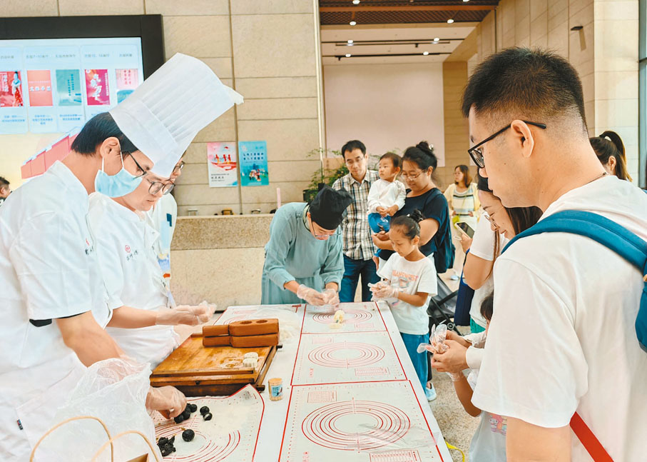 ●遊客在中國工藝美術館·中國非物質文化遺產館體驗月餅製作。 香港文匯報記者江鑫嫻   攝