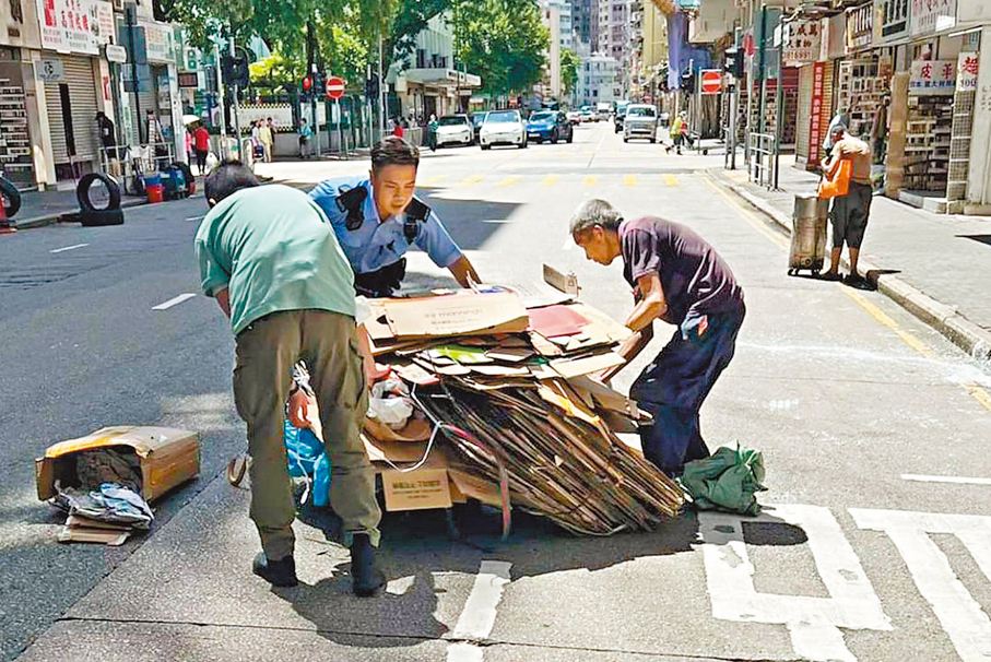 ●當日在警長王雅麟指揮下，警員李少華（穿制服）與便裝同袍落車幫助伯伯將紙皮執拾上手推車。