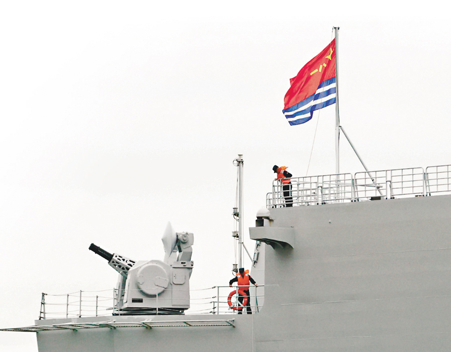 ●海南艦上官兵在甲板上升起海軍軍旗。 香港文匯報記者郭木又 攝