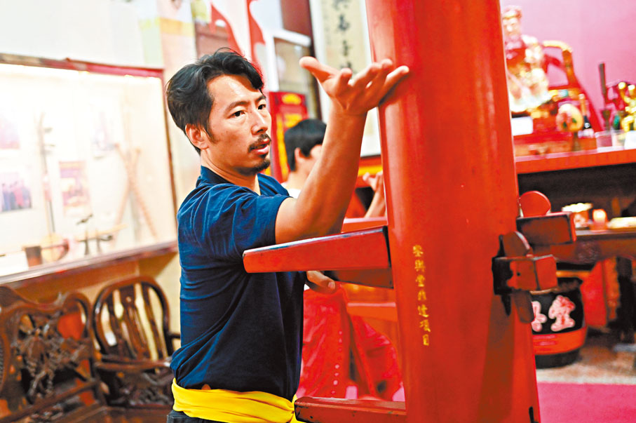 ●李健豪展示紅船木人樁的打法。 中新社