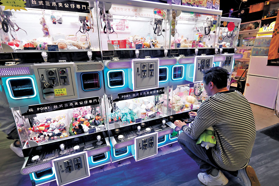 ●夾公仔機利用玩家以小博大的心理，不斷投幣換取心頭好，但當中卻充滿各種不平等條款。 香港文匯報記者涂穴  攝