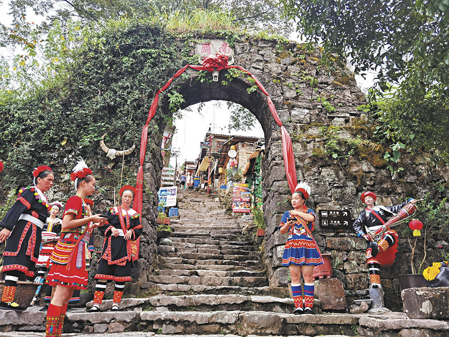 ●身穿節日盛裝的瑤家兒女在寨門前迎賓。 作者供圖