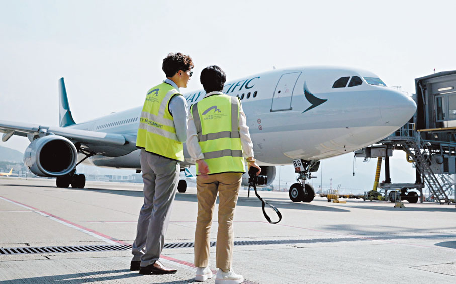 ●張艾嘉與機管局飛行區經理Stephen在停機坪觀察飛機。視頻截圖