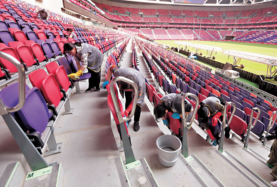 ●工作人員清潔啟德主場館看台。香港文匯報記者郭木又  攝