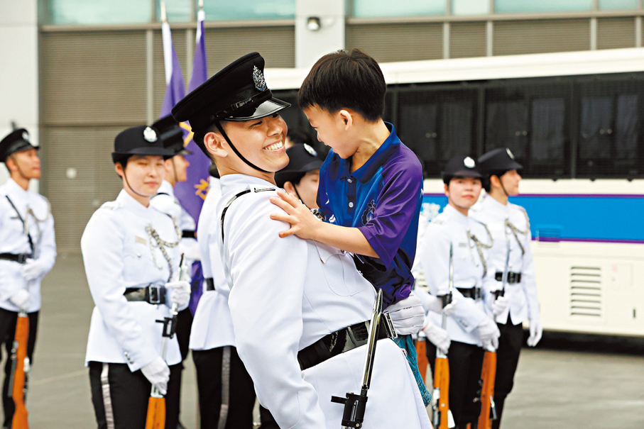●小朋友與入境處儀仗隊成員親切合影。 香港文匯報記者萬霜靈  攝
