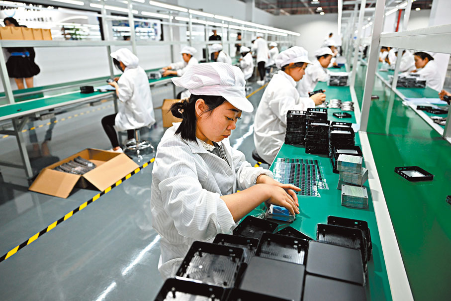 ●中國對全球經濟增長的年均貢獻率為30%左右。圖為四川省成都市,漢諾雲智智慧工廠中,工人組裝智能雲盒。中新社