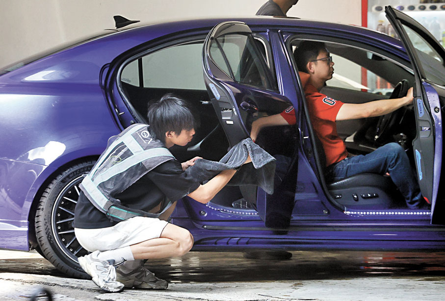 ●車房職員打理客戶汽車，務求做到「蠟蠟靚」。 香港文匯報記者郭木又  攝