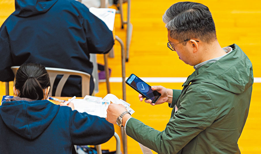 ●DSE考試開考後，監考員透過「監考易」應用程式為考生點名。 考評局網誌圖片