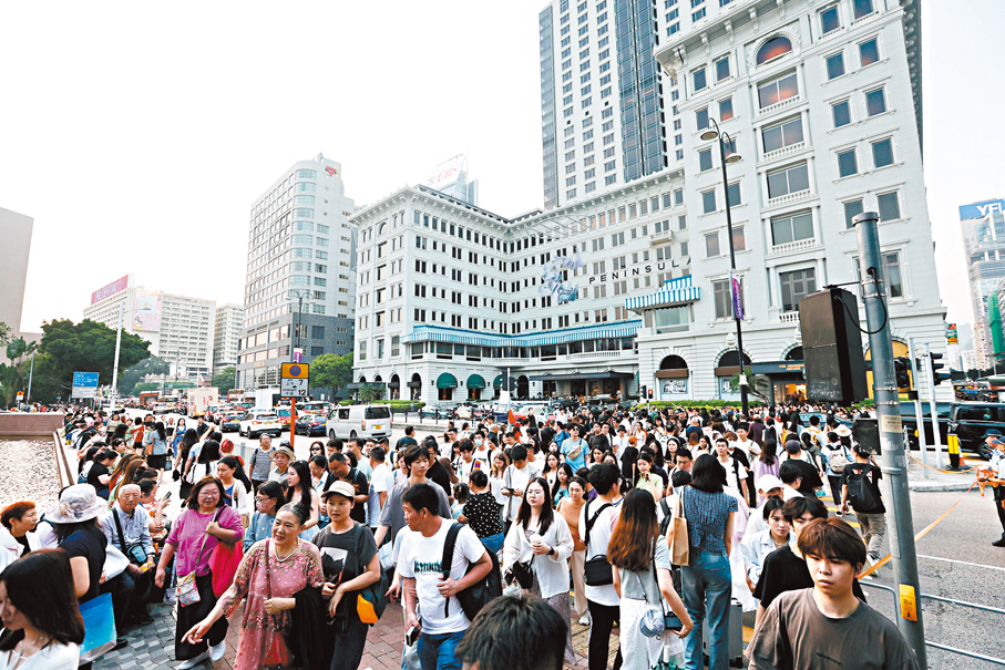 ●尖沙咀梳士巴利道人潮如鯽,警員拉起黃帶疏導行人過馬路。 香港文匯報記者曾興偉 攝