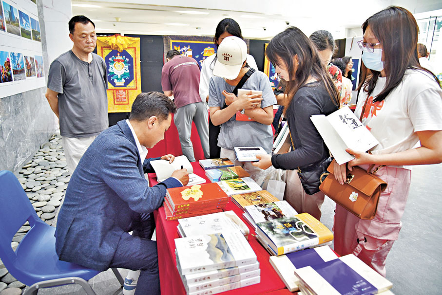 ●青海青年作家索南才讓為澳門市民簽名贈書。
