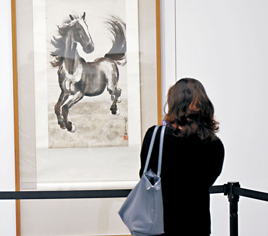 ●觀眾駐足觀賞畫作。   萬霜靈 攝