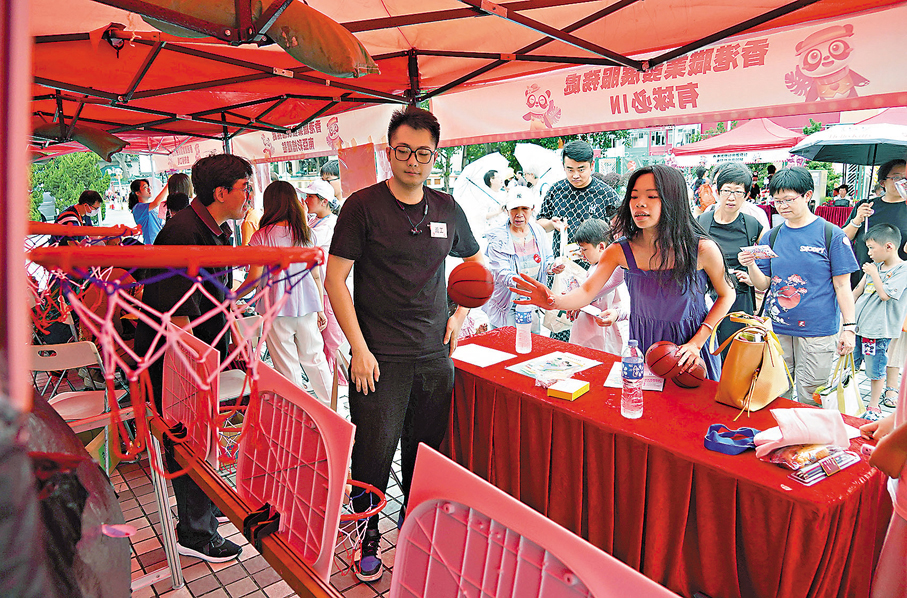 ●少女玩攤位遊戲。香港文匯報記者曾興偉  攝
