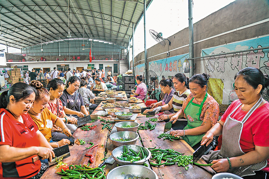 ●6月27日，村民在貴州省榕江縣忠誠鎮一處後勤伙食保障點切菜。 新華社
