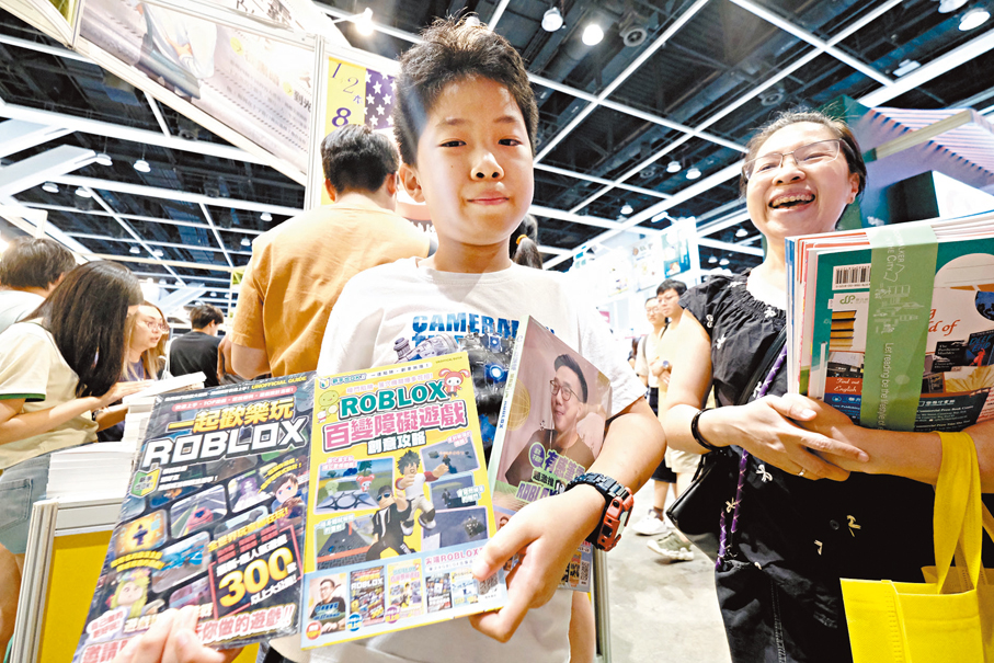 ●家長羅太特意拖篋來書展，帶同今年準備升小學五年級的兒子入場，表示已經斥資一千多元購買練習書及課外書本，給兒子在空閒時閱讀。香港文匯報記者涂穴  攝