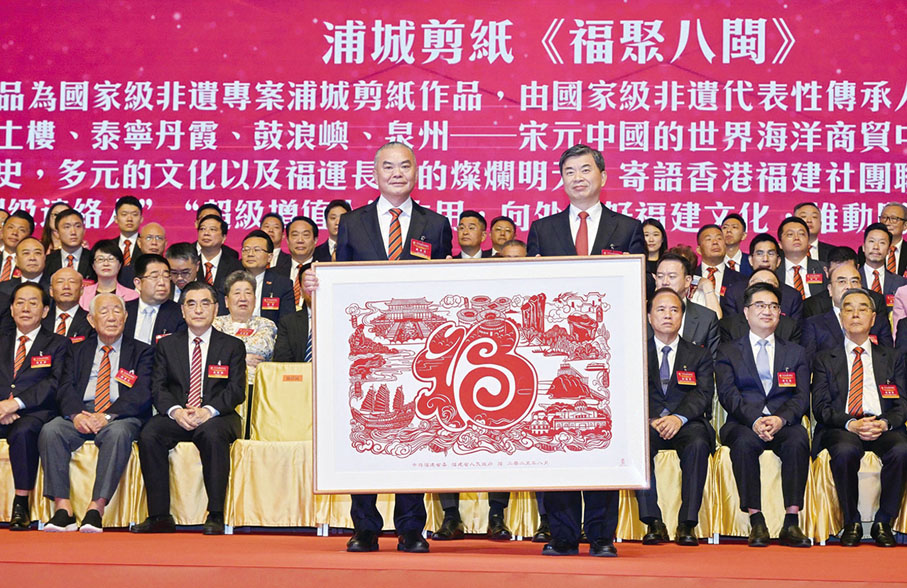 ●周祖翼(右)向香港福建社團聯會致送紀念品,施清流(左)代表接受。