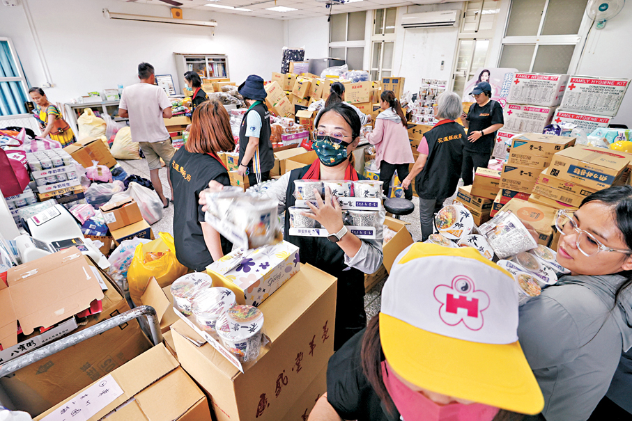●花蓮馬太鞍溪堰塞湖溢流釀災，目前已致17人遇難、32人受傷、17人失聯。圖為工作人員正整理分配物資。 中央社