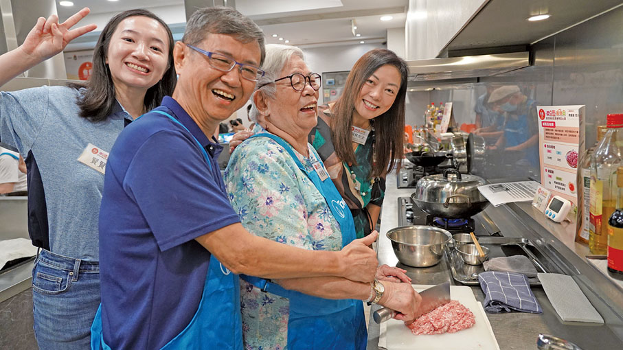 ●煤氣公司企業事務及政府關係總監王佩兒（右一）與煤氣公司義工全情投入，與參加者分享烹飪樂趣。
