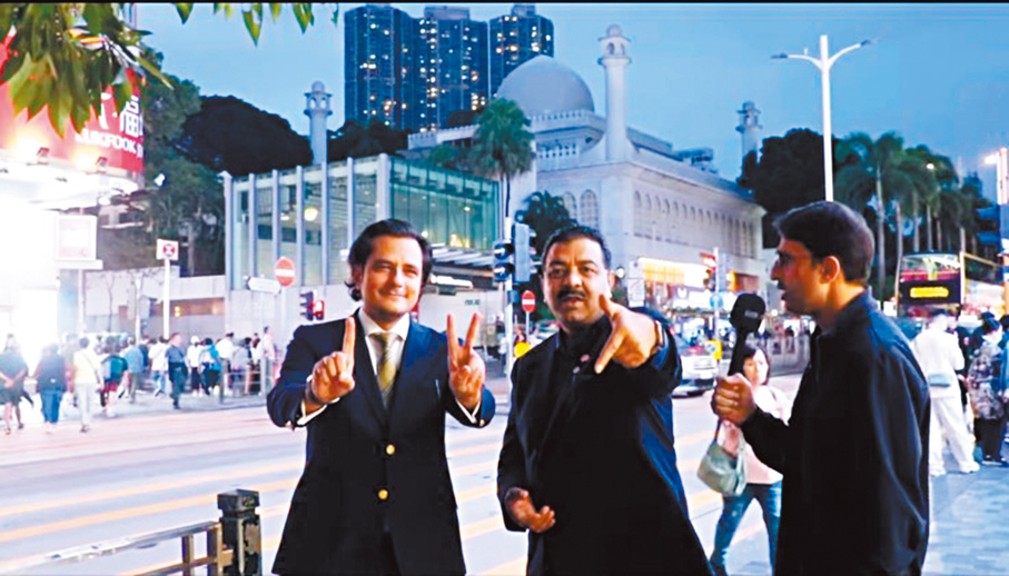 ●艾歷斯（中）與利哲宏（左）拍視頻呼籲鄉親投票。 視頻截圖