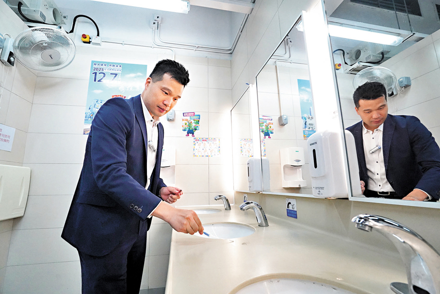 ●黃孝祥於公廁現場實際操作ATP生物冷光儀，使用專用拭子在洗手盆的表面塗抹取樣。 香港文匯報記者曾興偉 攝